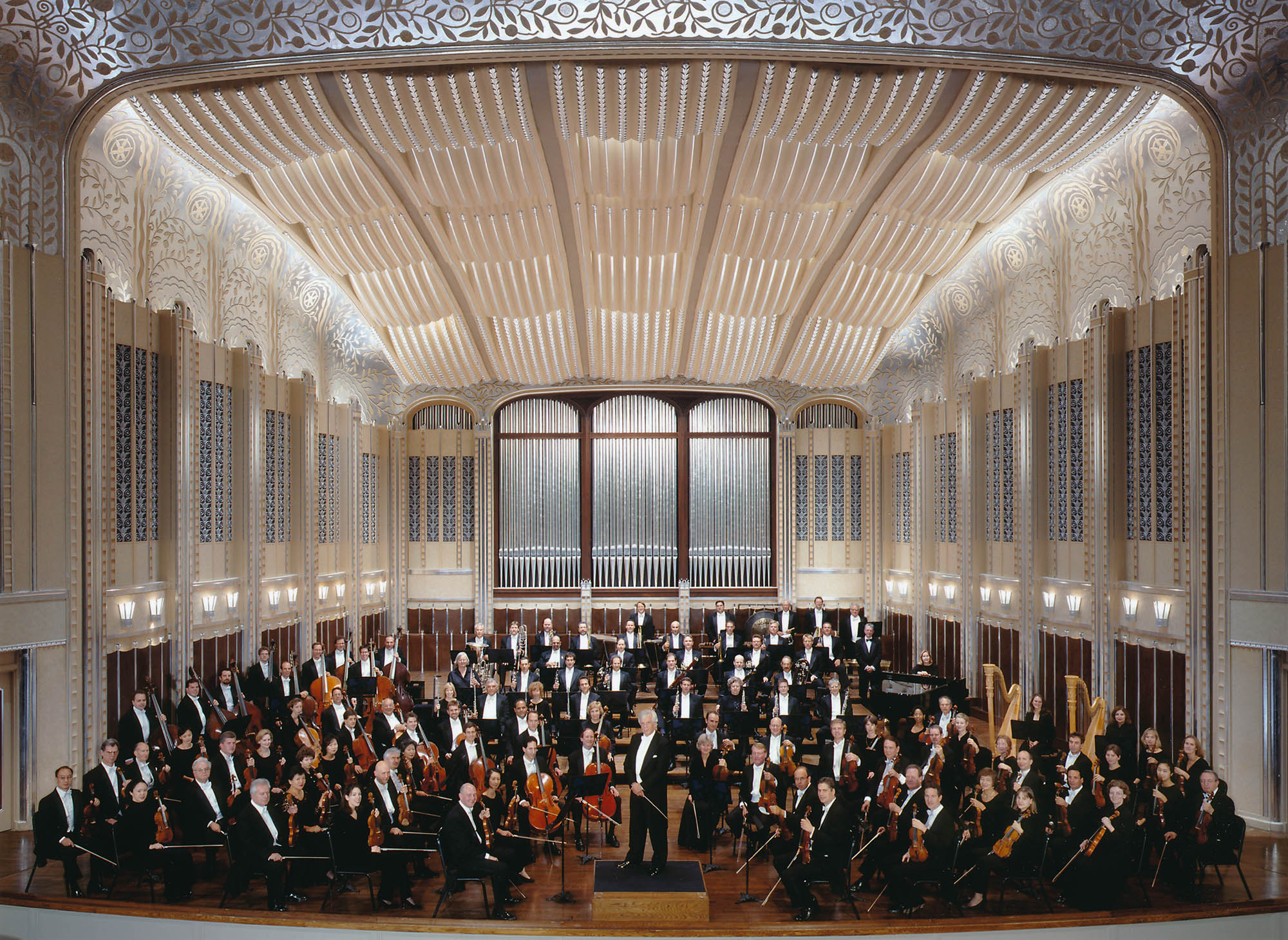 The Orchestra is seated on stage in Severance Hall, with von Dohnányi standing on the podium and looking towards the camera.  