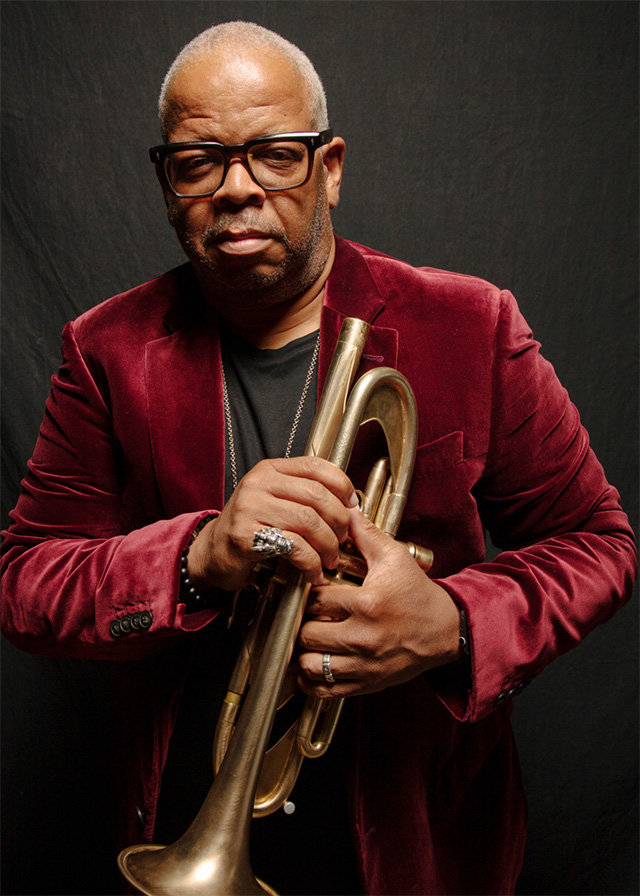 Terence Blanchard in a red jacket holding a trumpet