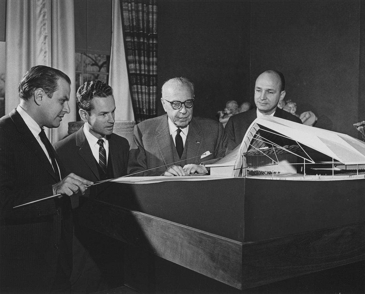 Christopher Jaffe (Acoustician), Louis Lane (Associate Conductor), George Szell (Music Director), and Peter von Dijk (Architect) discuss an early model of Blossom Music Center