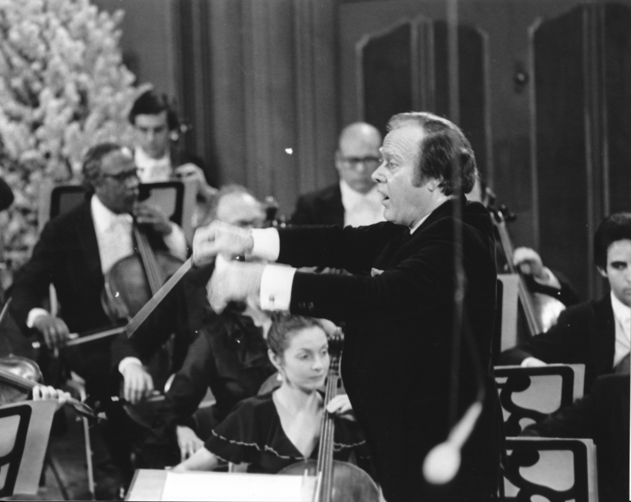 Page leads musicians on the decorated Severance stage for a 1979 Holiday Concert