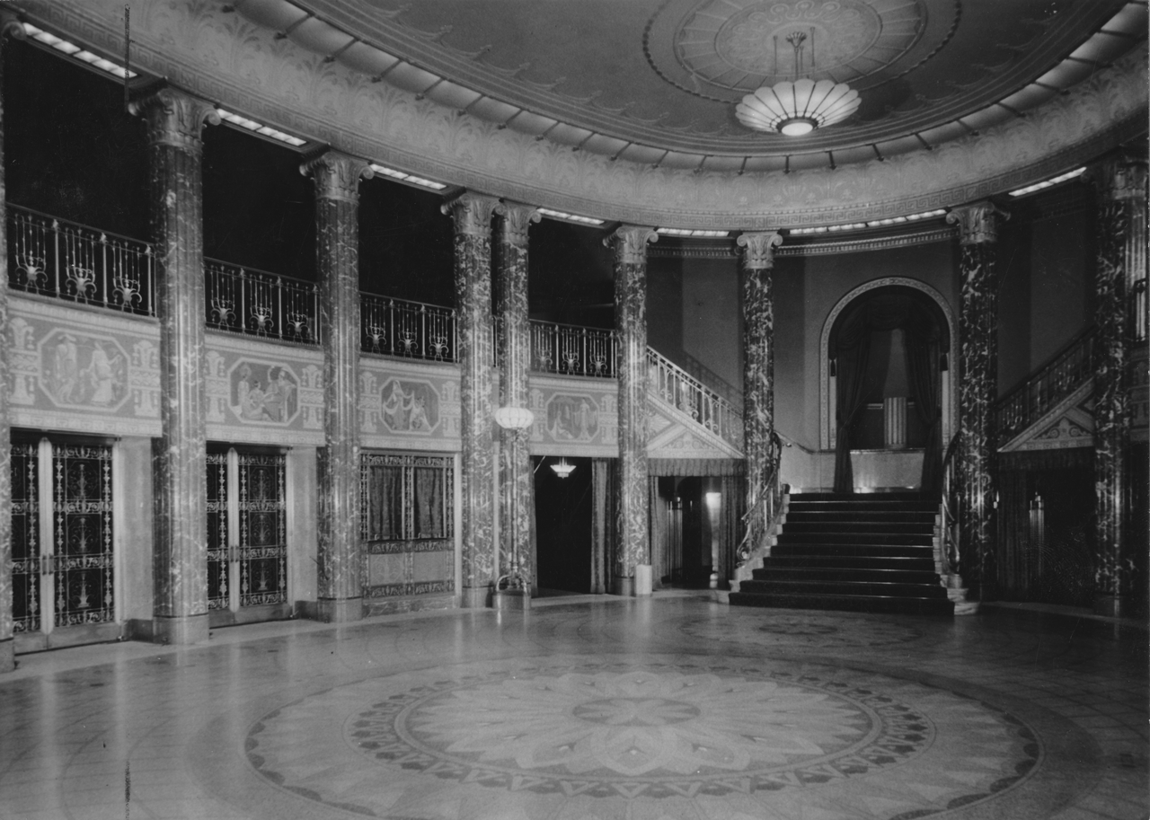Photograph of the Grand Foyer from 1931. Notice the lotus flower pattern in the marble flooring paired with the lotuses on the ceilings and lights. 